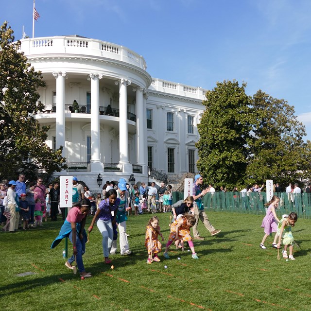 Children rolling eggs on the South Lawn