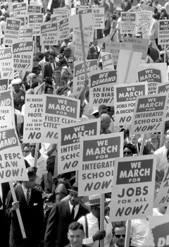 Demonstrators marching in the street holding signs during the March on Washington, 1963 Demonstrators marching in the street holding signs during the March on Washington, 1963
