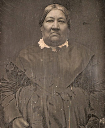Photograph of Marguerite McLoughlin wearing a dark dress