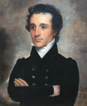 Portrait of a white man with black hair in a military uniform with his arms crossed.