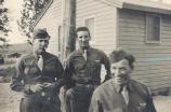 Paul Polink in 1940s, waiting for bus ride to Anchorage (Polink in middle)