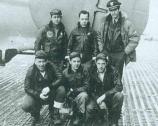 Six airmen pose in front of their bomber