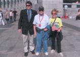 three people standing in front of memorial