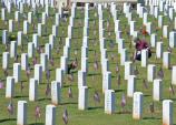 Volunteer straightening flags
