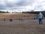Volunteers place luminaries in an open field