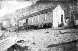 The class of 1905 stands in front of the school house in Worley, Kentucky.