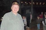 VIP Lynn LaBudde helps tend the campfire activities at the park Owl Prowls.
