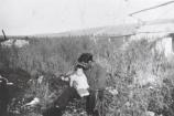 Paul Cusma holds baby Hilda Cusma at Newhalen River Fish Camp in 1946.