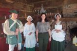 Park staff and costumed interpreters in cabin