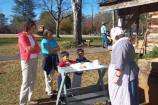 Families watch reenactor bake in beehive oven