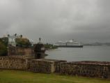 wall section next to La Fortaleza and a cruise ship entering the San Juan Bay.