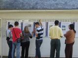 Students reading Shackles of Memory exhibit.