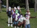 Kids wearing masks they made at the Kids' Corner