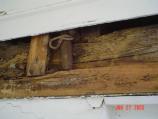 Shows disintegrated sill beam in kitchen house.