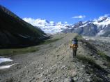 Backpacker crossing glacial moraine