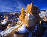 a strange looking hoodoo with snow