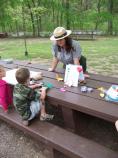 Park Ranger Natasha Moore working with a young visitor on Junior Ranger Day activities.
