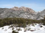 Cochise Head rises above snowy hills.
