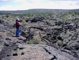 A hiker takes in the panorama of the McCartys Lava Flow.