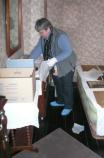 The Curator packs the personal belongings of Harry Truman for storage. Each artifact is carefully wrapped and noted on a packing list kept with the box.
