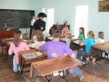 A park ranger portrays a teacher in the Storys Creek School.