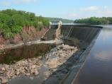 Little water goes over the dam, but rather is released from the base after making electricity. The drop is 60 feet and requires a mile long portage.