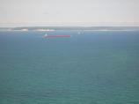 View of North Manitou Island, the North Manitou Island Shoals Lighthouse, a freighter from Pyramid Point.