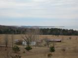View of Thoreson farm from the Bay View Trail. The farm and fields can be seen better because the leaves are not on the trees blocking the view.