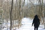 A visitor walking in the snow on the trail