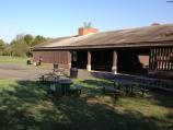 Large wooden picnic pavilion with paved loading zone