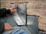 New stepped counterflashing is installed during Thomas House slate roof replacement