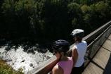 2 bikers look onto the river below
