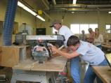 Students in shop class cutting wood.