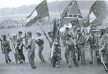Reenactors bearing flags of fifty Confederate units and states march to the Angle, July 3, 1963.