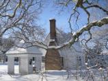 Picture of snow resting majestically at George Washington Birthplace National Monument. This picture shows the Colonial Kitchen and Gazebo