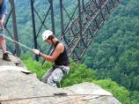 rock climber starts over the edge of the gorge