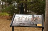 This wayside exhibit and bronze statue mark the fourth stop along the interpretive trail.