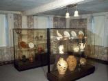 The hall of the Narbonne House is one of two original rooms of the house. Today, glass cases display some of the archaeological artifacts spanning three hundred years that were found in the backyard.