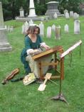 Re-enactor and musician Linda Russell performs a song from the 18th Century on a dulcimer in the cemetery of St. Paul's Church NHS.