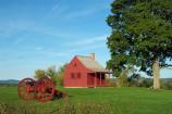 Late afternoon summer sun brings out the deep red of this one-room farmhouse that served as a mid-level headquarters building for the American army during the Battles of Saratoga.
