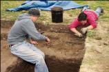 Students excavate a site as part of the site's 2005 Archaeology Field School.