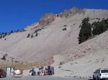 Lassen Peak towers over a group of hikers as they prepare for their trek up the trail.