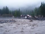 The Nisqually River at full flood flows past the Emergency Operations Center at Longmire.