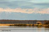 Kolkheti National Park: Ranger shelter on Paliastomi Lake with the Caucasian mountain range in the background.
