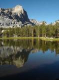 Reflection of an unnamed peak in the still waters of a Big 5 Lake