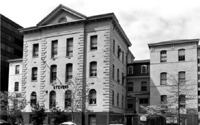Black and white photo of four-story school made of stone. Courtesy NPS. 