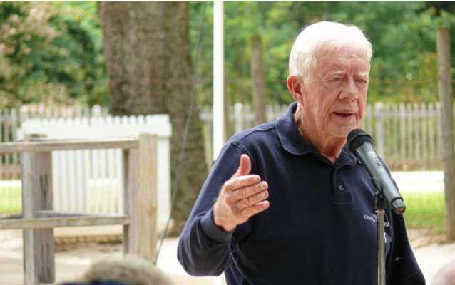 President Carter speaks to a group of visitors.