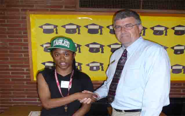 Park employee shaking hands with student who is giving thumbs up sign