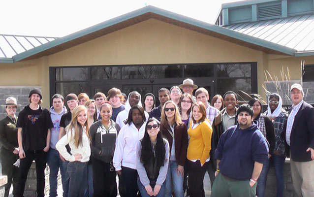 Park rangers and students in front of the visitor center