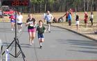 Families cross the finish line together at the Race for the Grasshopper